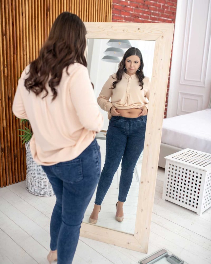 brunette-woman-looking-at-herself-in-mirror-2026-03-09-23-55-11-utc